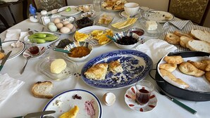 A table set with various dishes, including bread, eggs, and a bowl of jam. - Mavi Ladin Konukevi (Kars)