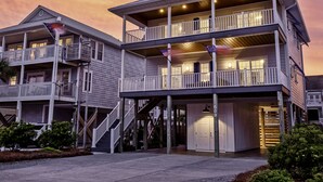 A multi-story building with balconies, a staircase, and a porch area.