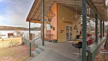 Relax in a scenic outdoor space with a wooden deck and seating area overlooking a body of water.