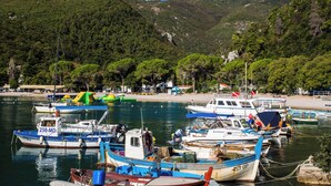 A marina with boats docked, surrounded by lush greenery and a mountainous backdrop. - Holiday home with panoramic view and large terrace (Lovran)