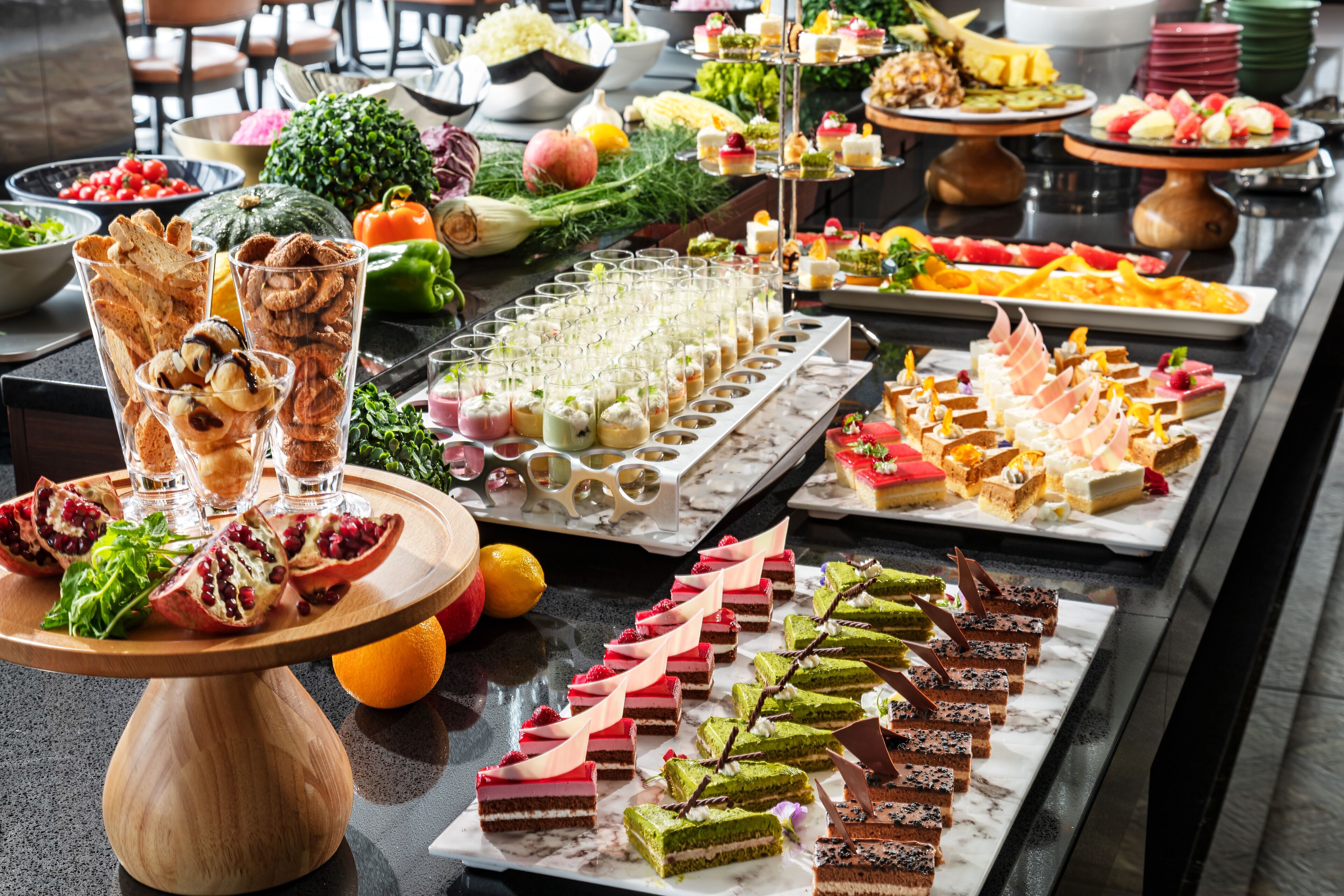 A buffet table with various food items and drinks.