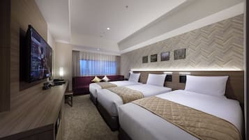 A hotel room with two beds, a TV, a desk, and a window with curtains.
