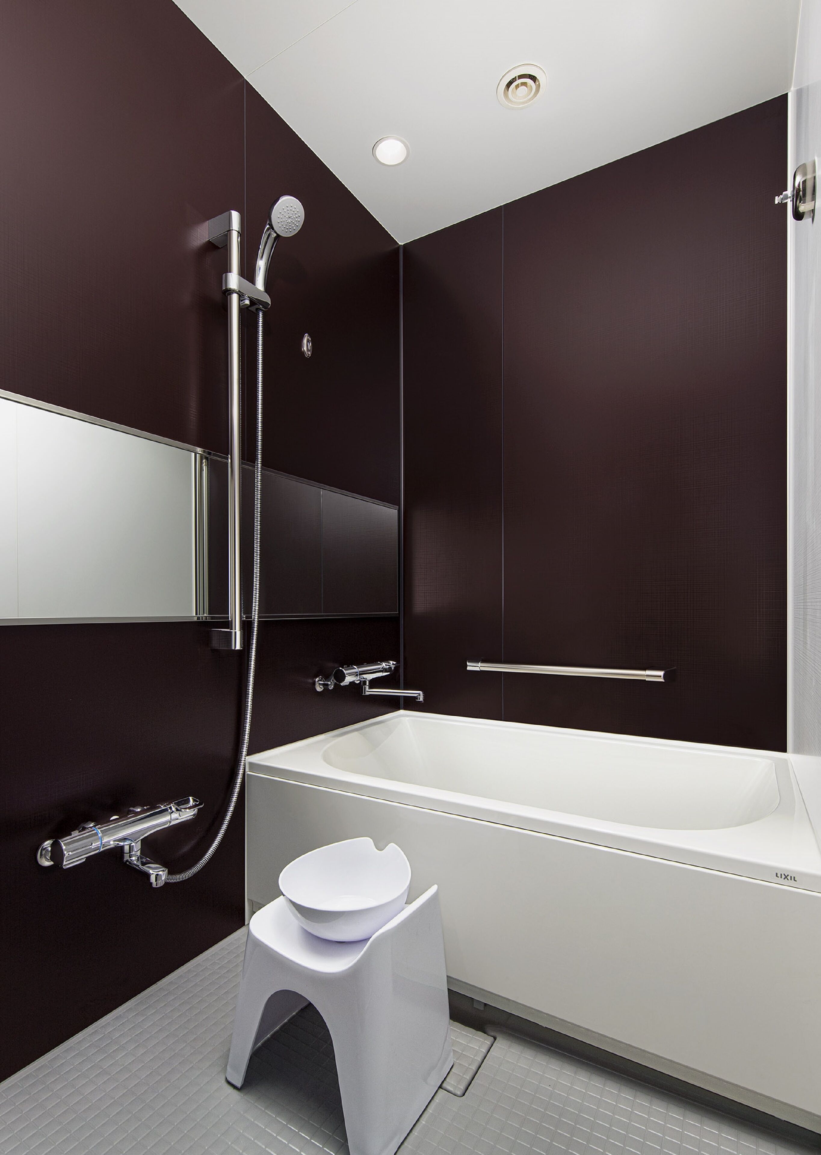 A modern bathroom with a bathtub, a toilet, and a shower.