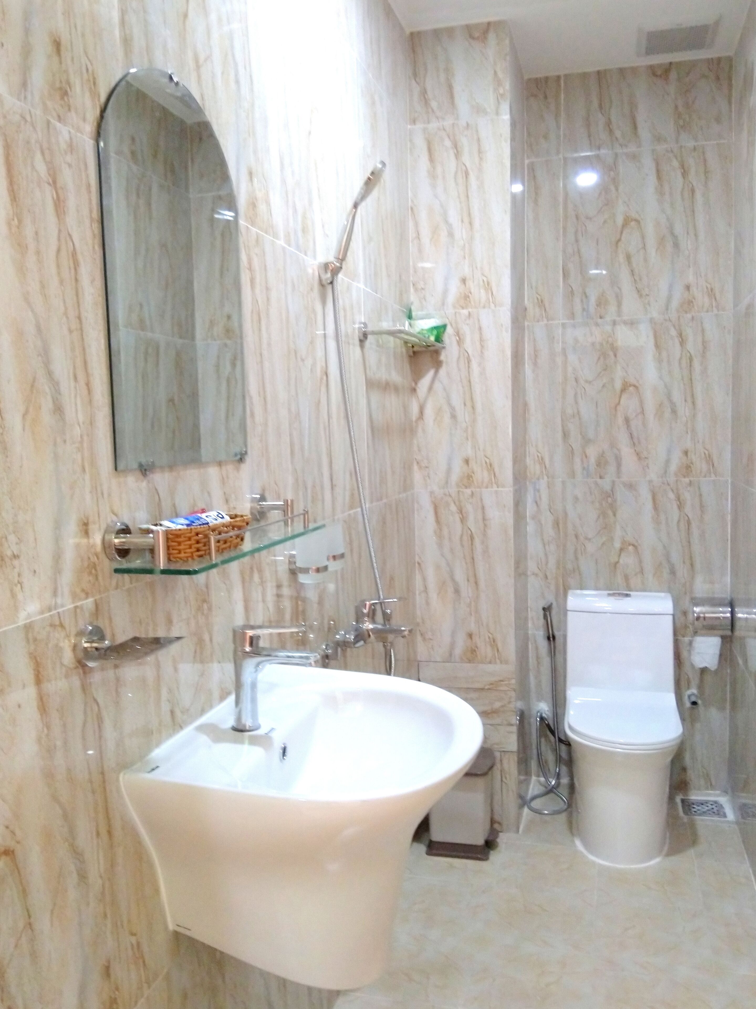 designer toiletries, hair dryer, slippers, bidet