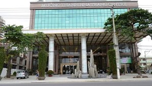 A modern building with a large glass facade and a sign reading "MUKONG THANHINHATURANG CENTRE". - Nina Apartments (Nha Trang)