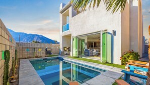 A modern house with a swimming pool, a patio with outdoor furniture, and a view of mountains. - Mountain View Luxury Resort-Style Modern Home with a Private Pool. (Palm Springs)