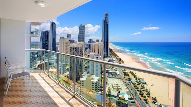 A balcony with a view of a beach and cityscape. - Peninsula Resort - Private Apartments (Surfers Paradise)