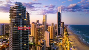 A coastal cityscape with high-rise buildings, a beach, and a clear sky. - Peninsula Resort - Private Apartments (Surfers Paradise)