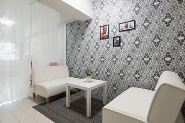 Standard Double Room | Living area | Flat-screen TV
