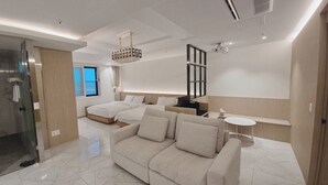 A modern hotel room with a large sofa, a separate bed, a small table, and a large window. - BrownDot Hotel Bong-Duk (Daegu)