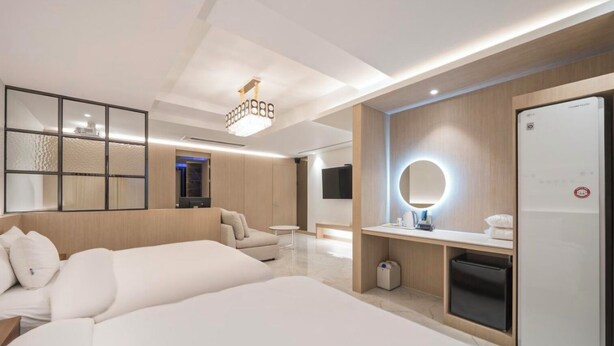 A modern hotel room with a large bed, a desk with a mirror, and a television. - BrownDot Hotel Bong-Duk (Daegu)
