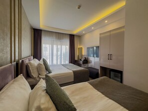 Standard Triple Room, City View | Minibar, in-room safe, blackout drapes, soundproofing