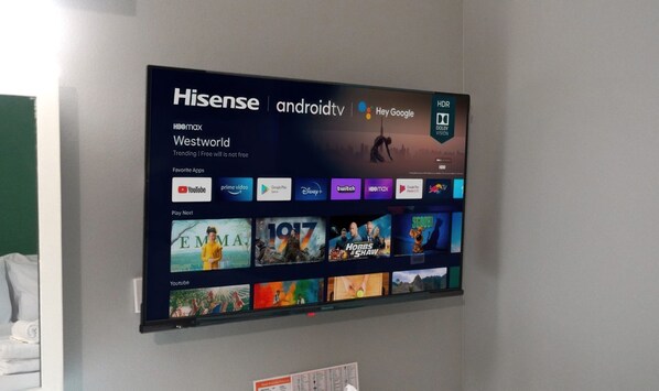 A Hisense TV mounted on a wall displaying a Westworld-themed interface with various streaming apps.