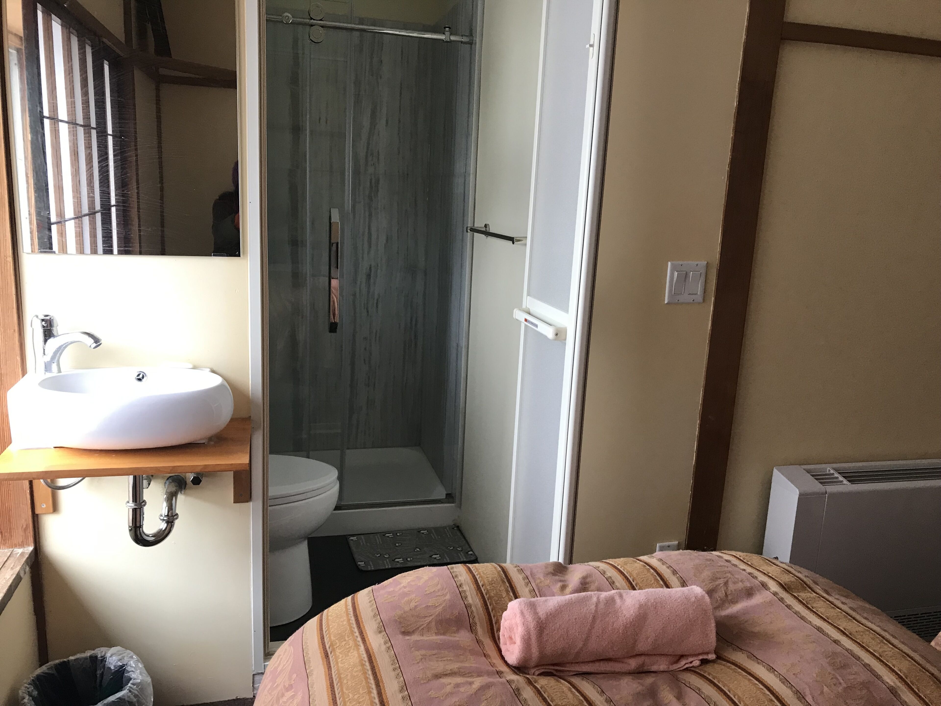 A bathroom with a sink, toilet, and shower.