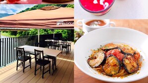A dining area with tables and chairs, a view of a river, and a restaurant sign. - Kanau (Gojo)