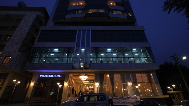 A hotel with a modern design, featuring a prominent entrance with a sign, multiple floors, and a well-lit facade. - Desalegn Hotels Lodge And Apartment (Addis Ababa)