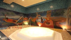 A room with a large bathtub, a mosaic wall, and a wooden ceiling. - Desalegn Hotels Lodge And Apartment (Addis Ababa)