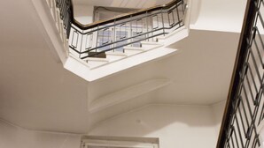 A multi-level interior with a staircase, a bicycle, and a window. - City heart Ülikooli Tartu Home Apts. (Tartu)