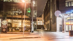 A nighttime street view with a restaurant named 'Luisa' and another named 'Isamapa' across the street. - City heart Ülikooli Tartu Home Apts. (Tartu)