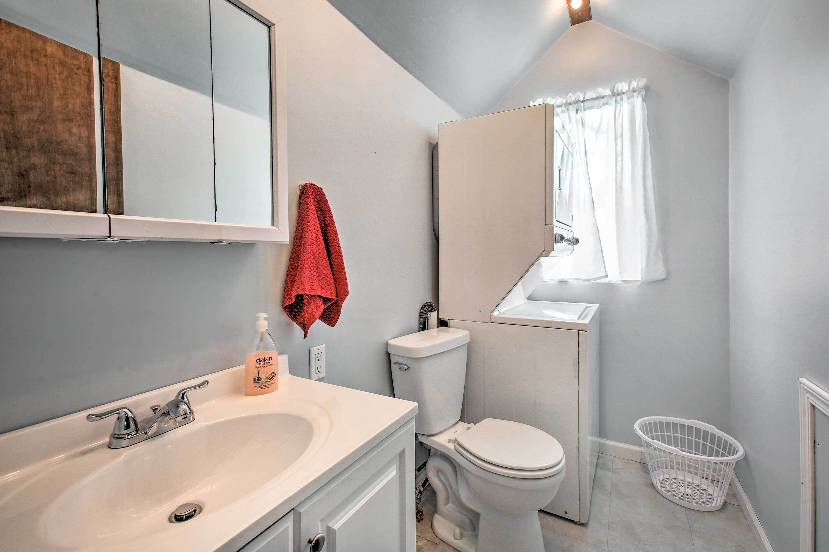 A bathroom with a white sink, a toilet, and a mirror above the sink.