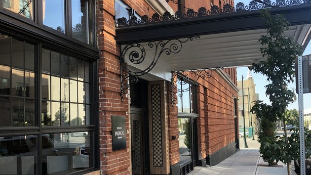 A hotel named 'Hotel Indigo' with a brick facade, large windows, and a covered entrance. - Hotel Indigo Spokane Downtown by IHG (Spokane)