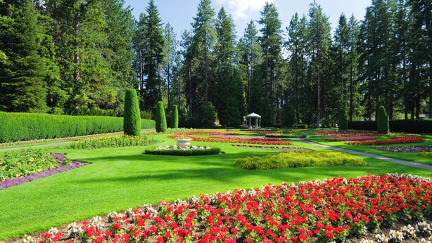 A formal garden with manicured lawns, flower beds, and a gazebo. - Hotel Indigo Spokane Downtown by IHG (Spokane)