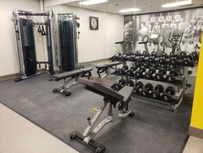A gym with weightlifting equipment, treadmills, and a wall with a motivational poster. - Hotel Indigo Spokane Downtown by IHG (Spokane)