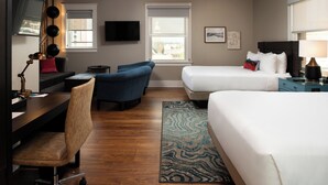 A hotel room with a bed, a desk, a chair, a TV, and a window. - Hotel Indigo Spokane Downtown by IHG (Spokane)