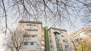 Ein mehrgeschossiges Gebäude mit moderner Architektur, mit Balkonen und großen Fenstern.
