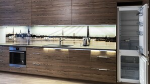 A modern kitchen with wooden cabinetry, a built-in oven, a stainless steel sink, and a large window overlooking a cityscape. - WINWINSTAY Apartments Heart of Old Town (Riga)