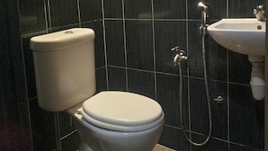 A bathroom with a toilet, a sink, and a shower. - Healthy Home, Changkat Bukit Bintang (Kuala Lumpur)