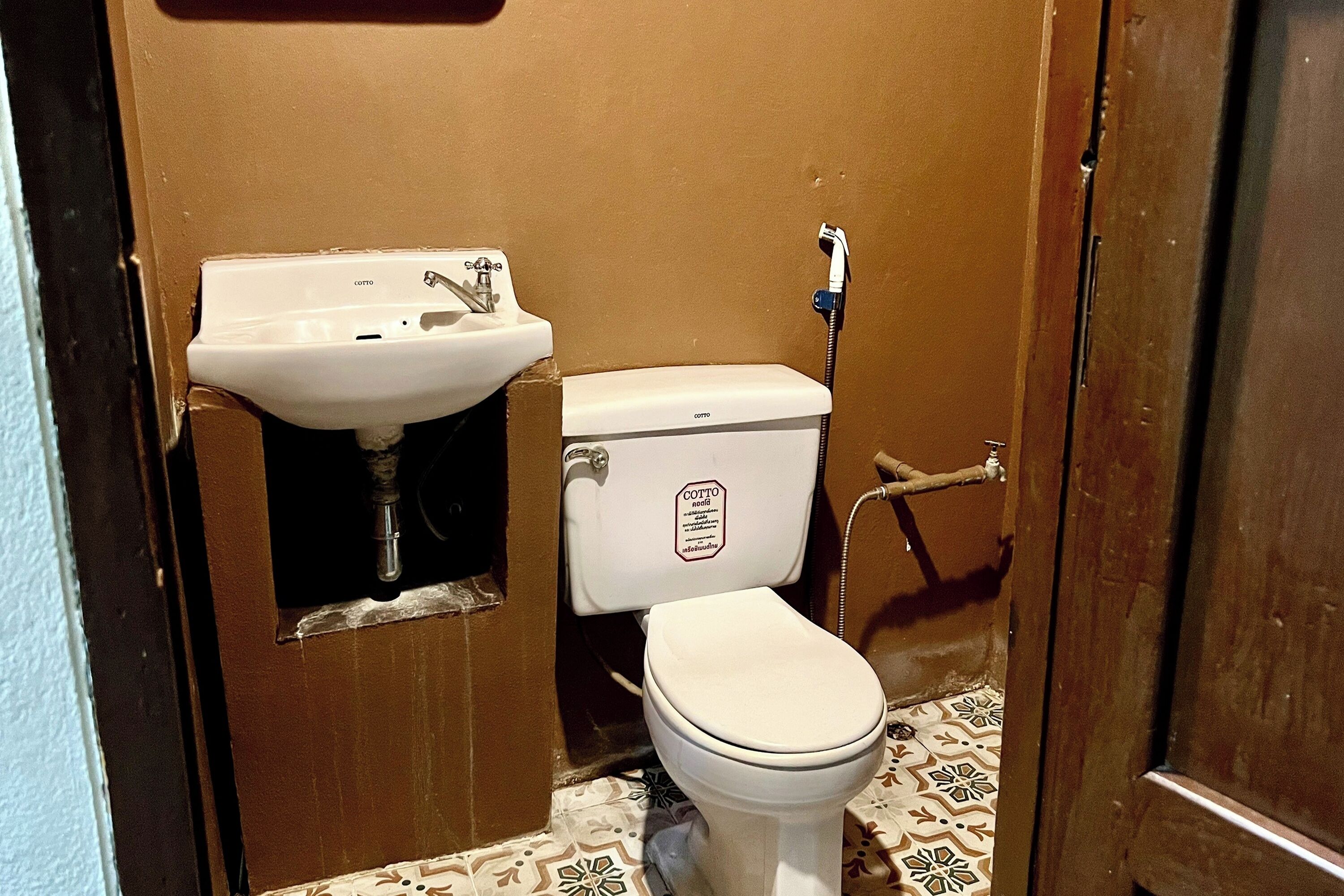 A small bathroom with a toilet, a sink, and a shower.