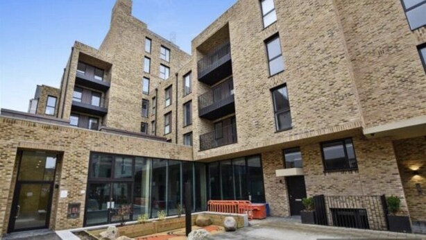 A multi-story building with a brick facade, large windows, and balconies. - Luxury 2 Bed 2 Bath Apartments next to kings cross (London)