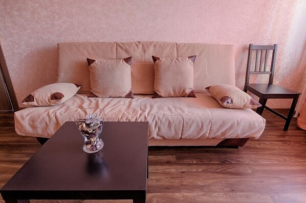 Relax in this inviting space with a comfortable sofa, wooden table, and natural decor.