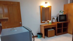 A room with a wooden door labeled 204, a small desk with a television, a mirror, and a trash bin. - Praew Mansion (Kamala)