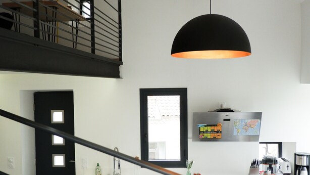 A modern kitchen with a central island, black railing, and a hanging pendant light. - La Grange 1832 - 10 mins from Aubenas (Saint-Étienne-de-Boulogne)