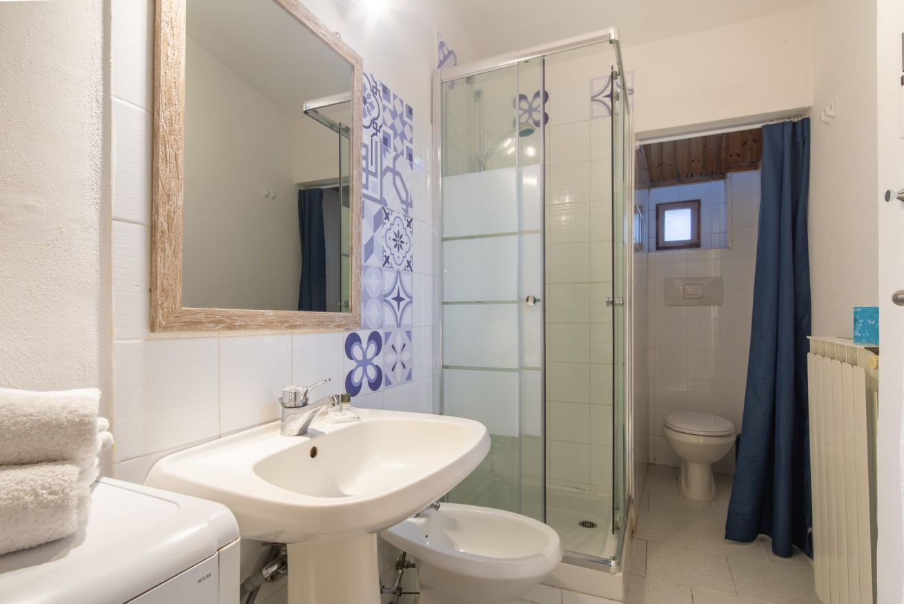 A bathroom with a sink, toilet, and shower.