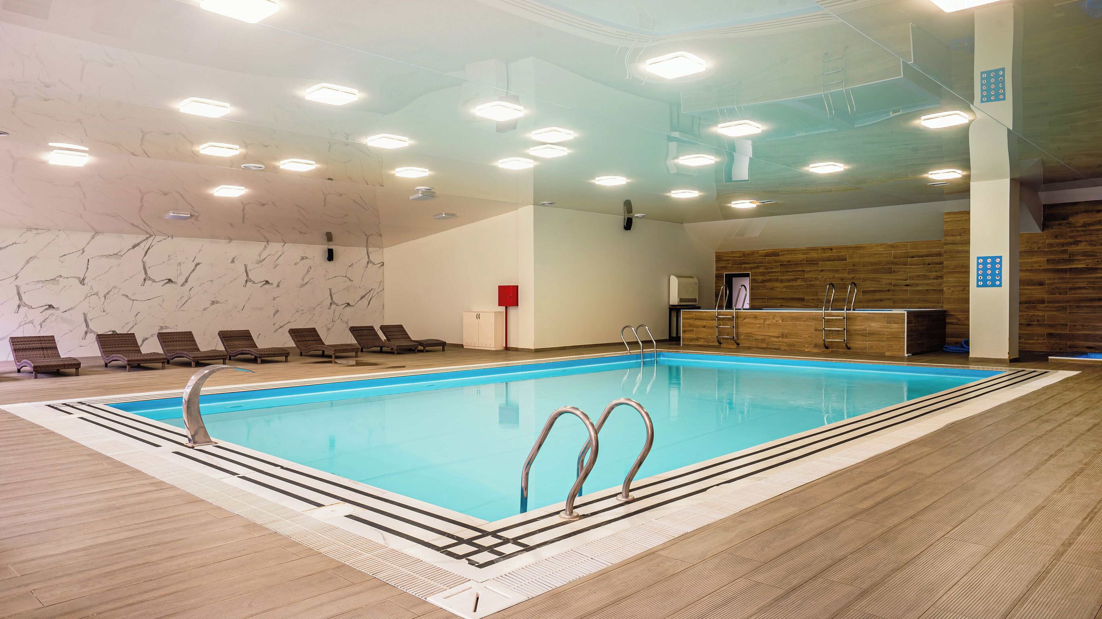 Indoor pool, open 10:00 AM to 10:00 PM, pool loungers