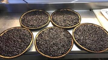 Four round pies with a textured surface, placed on a metal surface.