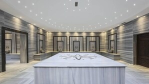 A spacious conference room with a large table, recessed lighting, and marble flooring. - Nevali Hotel (Sanliurfa)