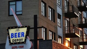 A multi-story building with a sign for "The Beer Depot" indicating a drive-thru service.