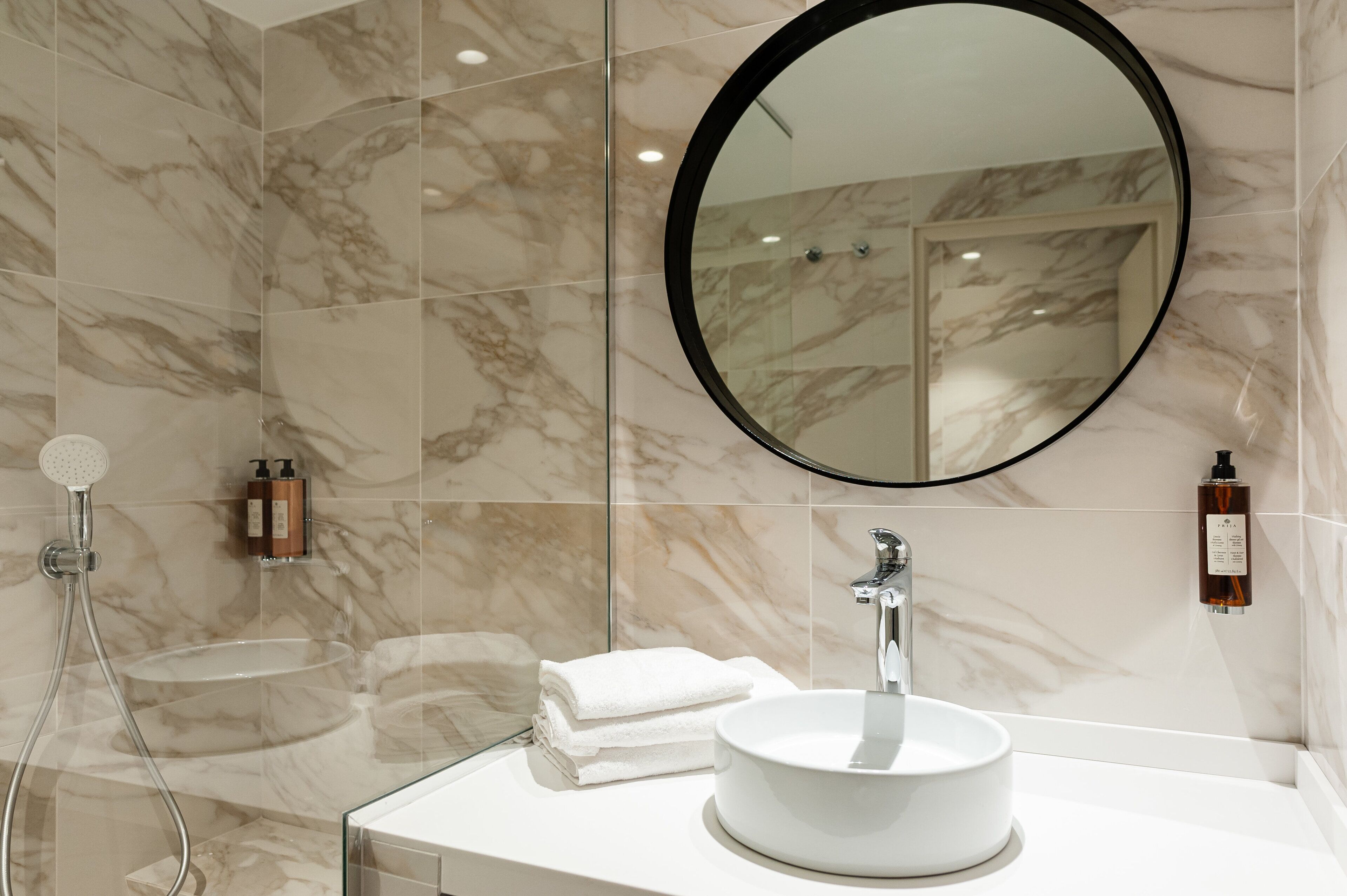 shower, hair dryer, slippers, towels