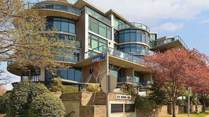 A modern multi-story building with large windows and balconies, located at 21 Erie St. - Harbourview Executive Condo (Victoria)