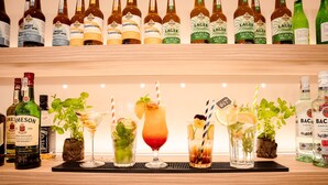 A bar area with various bottles of beer and spirits, and a selection of cocktails. - Holiday Inn Express Warsaw - Mokotow by IHG (Warsaw)