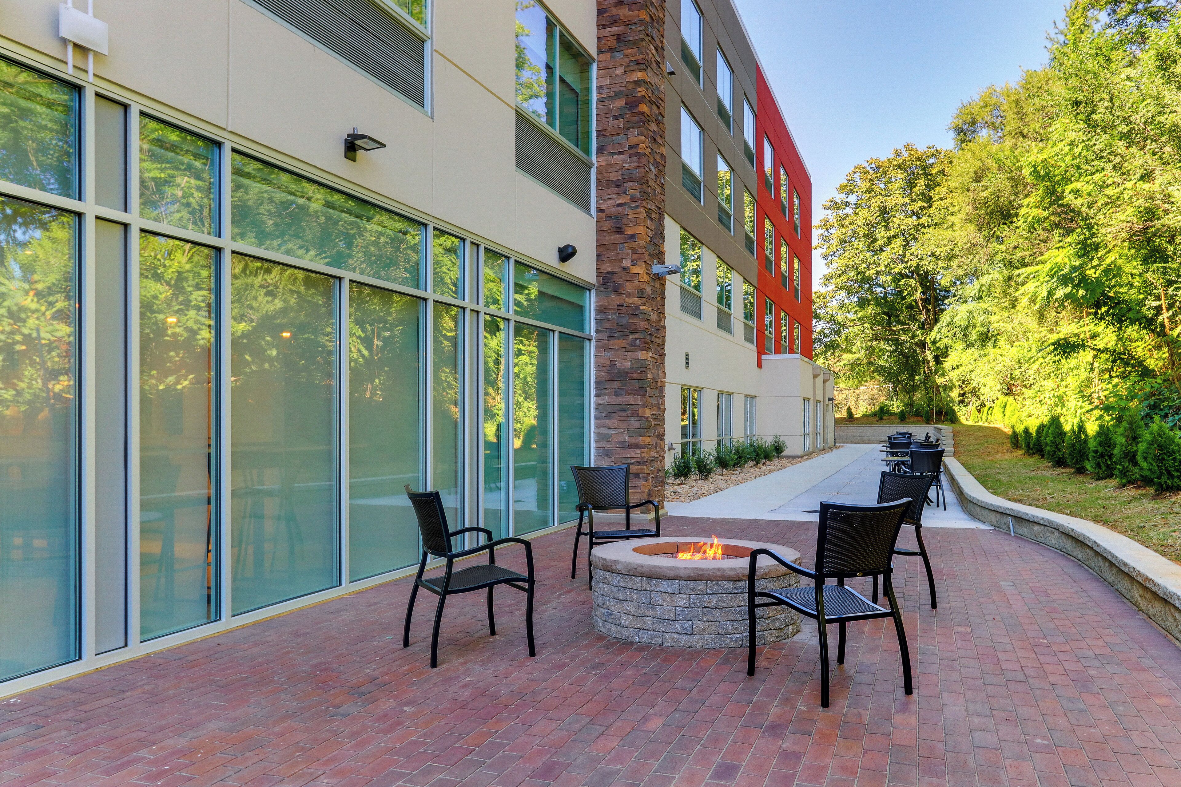 A patio area with a fire pit and outdoor seating.