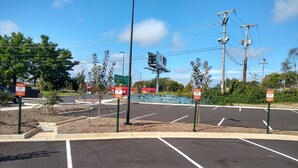 A parking lot with multiple parking spaces and a stop sign. - Holiday Inn Express & Suites Roanoke – Civic Center by IHG (Roanoke)