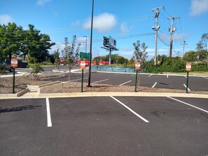 A parking lot with multiple parking spaces and a stop sign. - Holiday Inn Express & Suites Roanoke – Civic Center by IHG (Roanoke)