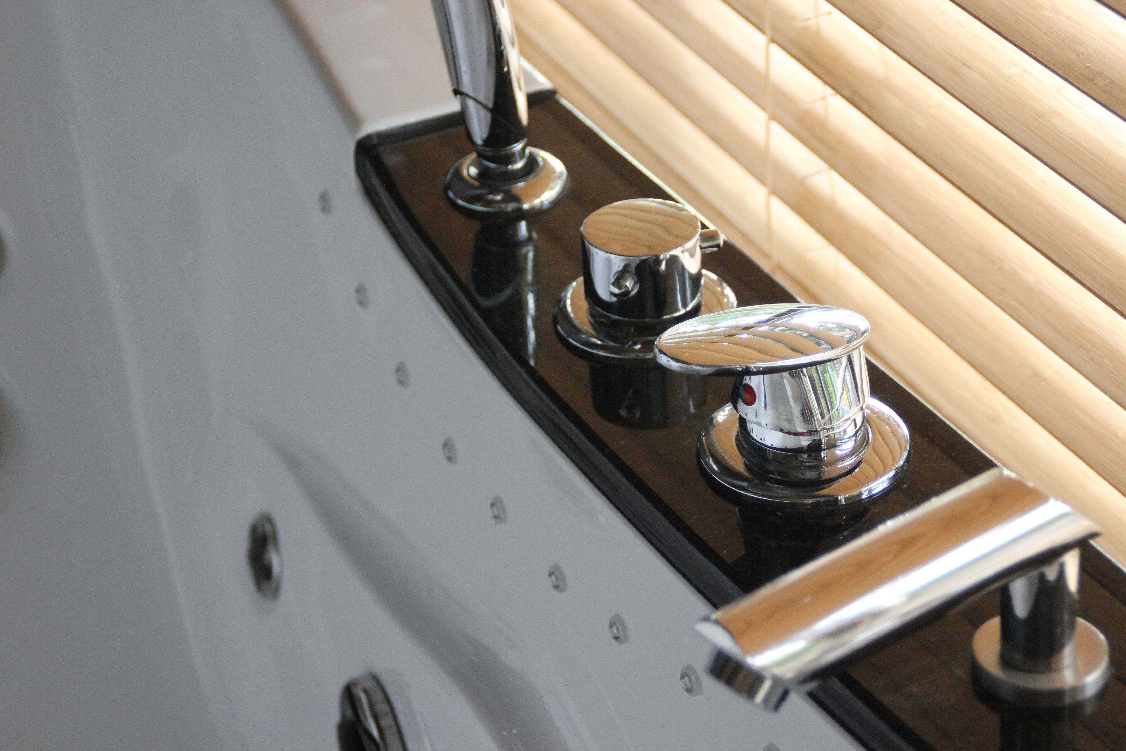 A polished metal surface with a reflective surface and a small metallic object on it.
