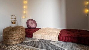 A cozy corner with a round woven ottoman, a cushioned bench, and a patterned rug. - 2394 Indiana (SIDE) · Perfect For Groups & Families-5 Bedroom Cozy Home (Columbus)