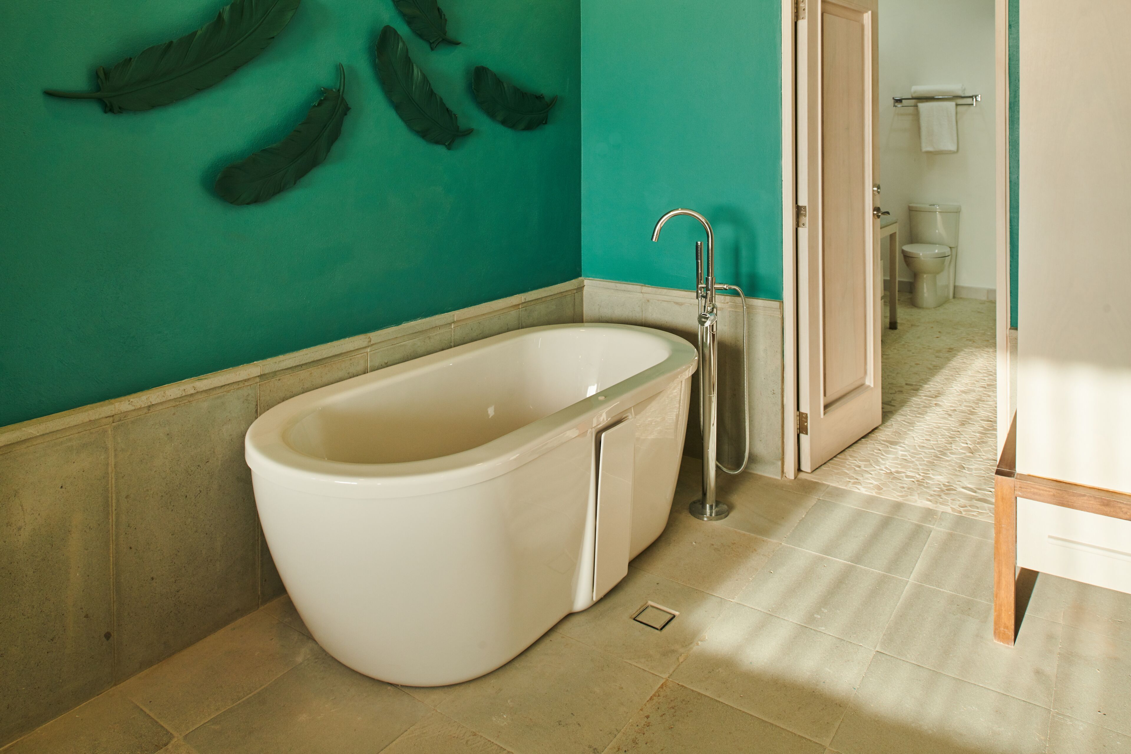 A bathroom with a freestanding bathtub, a sink, and a toilet.